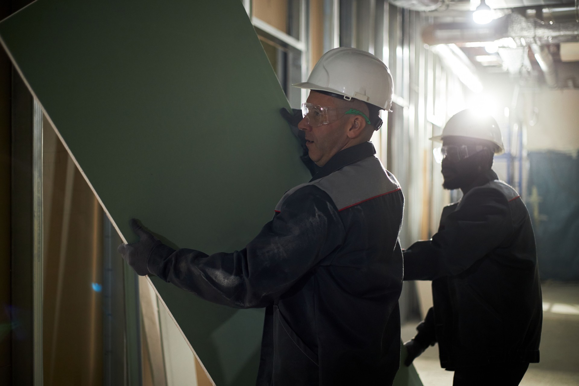 Men Carrying Drywall